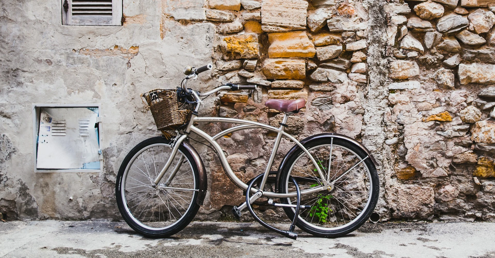 A traditional city bicycle with a curved top tube, front basket and rear rack.